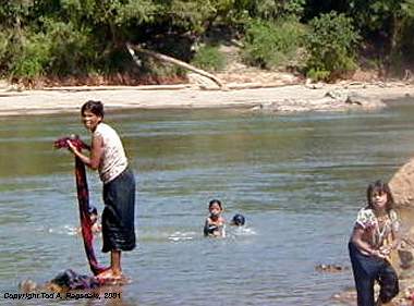 Montagnard (Jarai) woman and children washing, bathing in river, Central Highlands, Vietnam, 2000