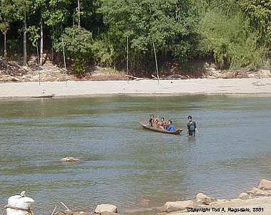 Montagnards (Jarai) cross river by dugout canoe, Central Highlands, Vietnam, 2000