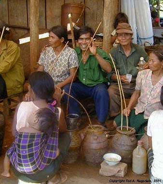 Montagnards (Jarai) drinking home brew 'ruou can,' Central Highlands, Vietnam, 2000